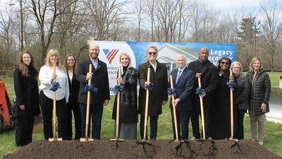 Group of partners holding shovels for groundbreaking ceremony.